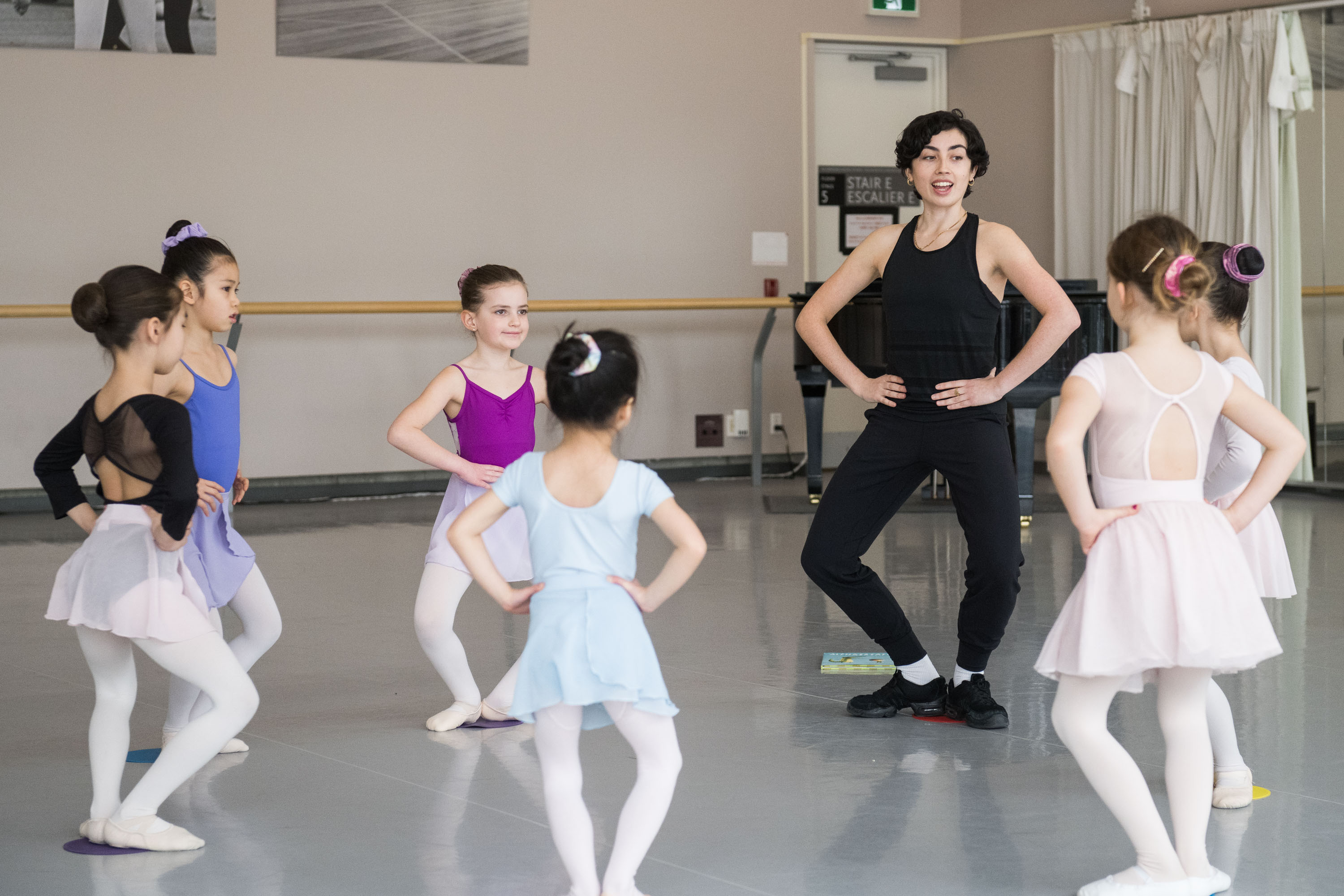 Students of the Young Dancers Program strike a pose in a ballet class.