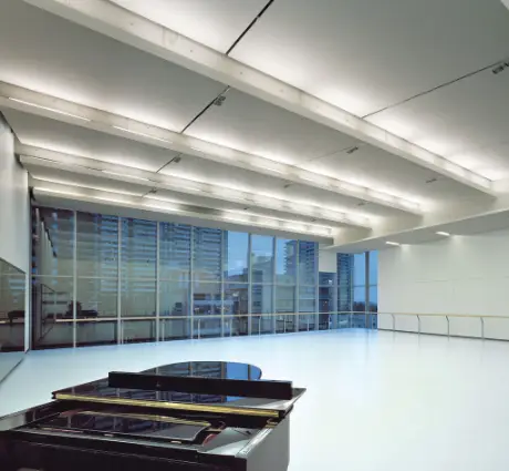 A brightly lit studio with a piano